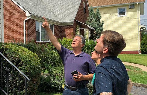 paul explaining home inspection to couple